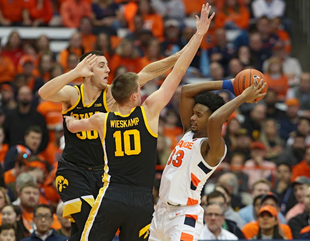 Iowa Hawkeyes guard Connor McCaffery (30) and guard Joe Wieskamp (10) pressure Syracuse Orange forward Elijah Hughes (33) during the second half of their ACC/Big Ten Challenge game at the Carrier Dome in Syracuse, N.Y. on Tuesday, Dec 3, 2019. (Stephen Mally/hawkeyesports.com)