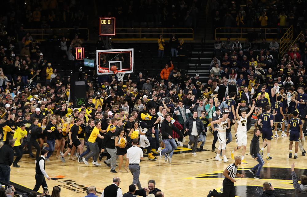 Fans storm the court after Iowa Hawkeyes defeated the Michigan Wolverines Friday, February 1, 2019 at Carver-Hawkeye Arena. (Brian Ray/hawkeyesports.com)