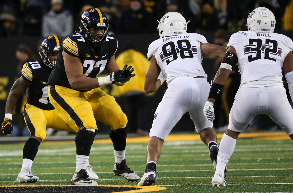 Iowa Hawkeyes offensive lineman Alaric Jackson (77) blocks during a game against Northwestern at Kinnick Stadium on November 10, 2018. (Tork Mason/hawkeyesports.com)