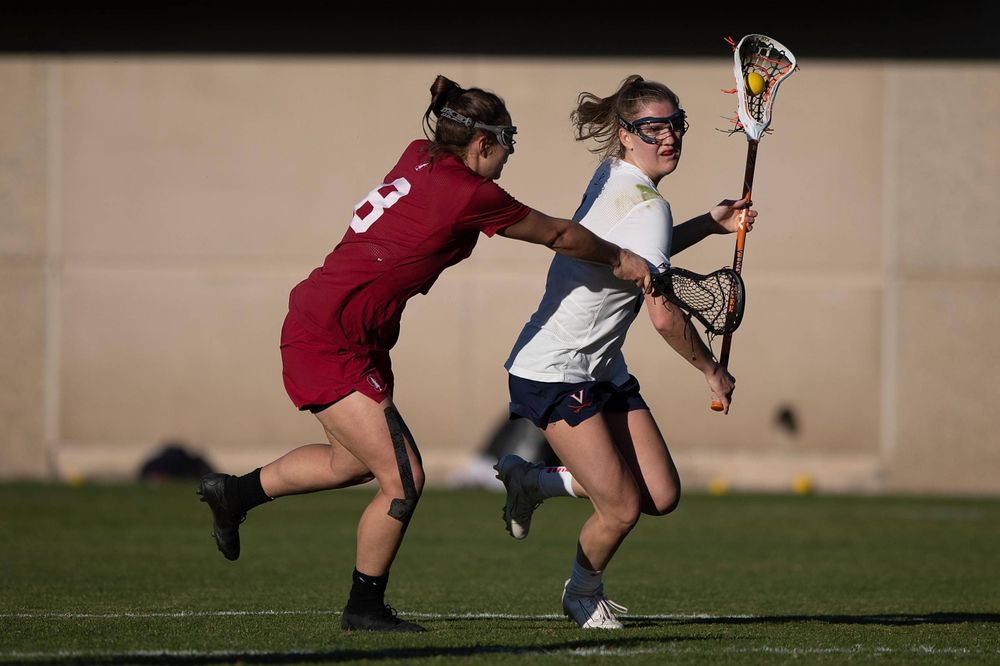 STANFORD, California - FEBRUARY 14: Virginia Cavaliers midfield Sammy Mueller (2) is defended by Stanford Cardinal defense Kyra Pelton (8) during the second half at Cagan Stadium on February 14, 2020 in Stanford, California. The Virginia Cavaliers defeated the Stanford Cardinal 12-11. (Photo by Jason O. Watson)