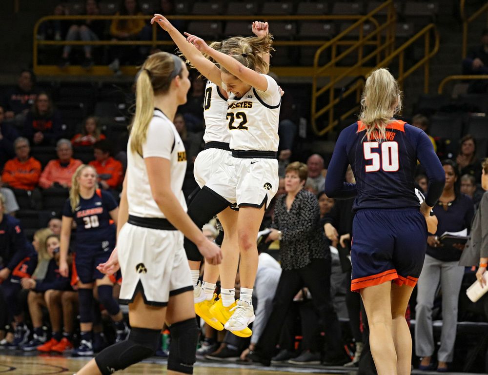 Iowa Hawkeyes guard Kate Martin (20) and guard Kathleen Doyle (22) celebrate during the fourth quarter of their game at Carver-Hawkeye Arena in Iowa City on Tuesday, December 31, 2019. (Stephen Mally/hawkeyesports.com)