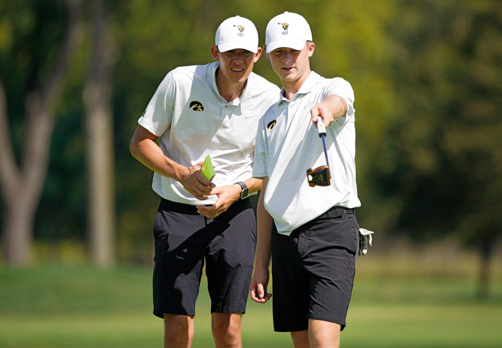 Iowa assistant coach Charlie Hoyle (from left) talks with Benton Weinberg during the second day of the Golfweek Conference Challenge at the Cedar Rapids Country Club in Cedar Rapids on Monday, Sep 16, 2019. (Stephen Mally/hawkeyesports.com)