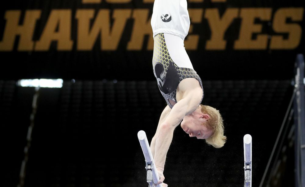 Iowa’s Nick Merryman competes on the parallel bars against Illinois Sunday, March 1, 2020 at Carver-Hawkeye Arena. (Brian Ray/hawkeyesports.com)