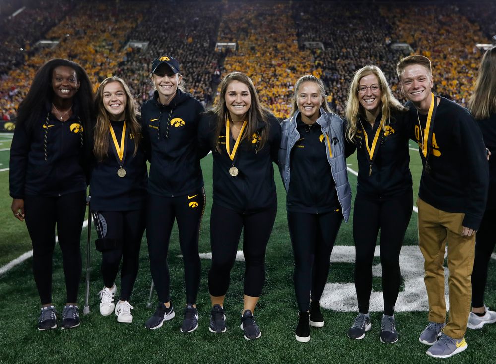Members of the Iowa men's and women's tennis teams are recognized by the Presidential Committee on Athletics at halftime during a game against Wisconsin on September 22, 2018. (Tork Mason/hawkeyesports.com)