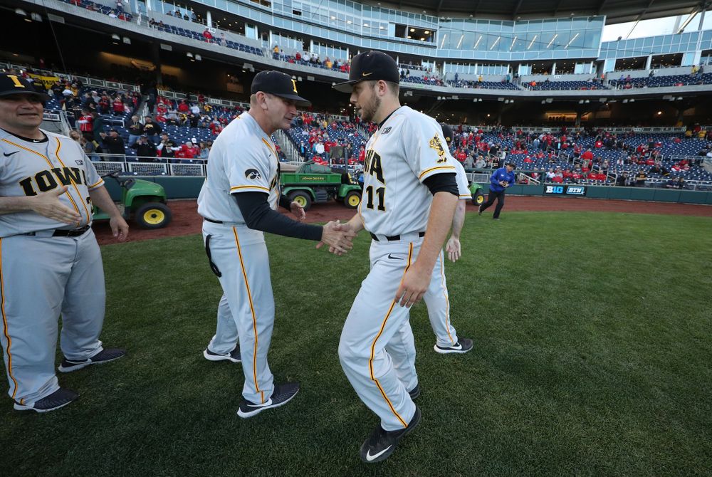 Iowa Hawkeyes head coach Rick Heller and Cole McDonald (11) against the Indiana Hoosiers in the first round of the Big Ten Baseball Tournament Wednesday, May 22, 2019 at TD Ameritrade Park in Omaha, Neb. (Brian Ray/hawkeyesports.com)