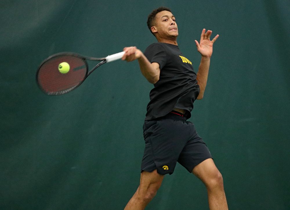 Iowa’s Oliver Okonkwo hits a shot during his match against Marquette at the Hawkeye Tennis and Recreation Complex in Iowa City on Saturday, January 25, 2020. (Stephen Mally/hawkeyesports.com)