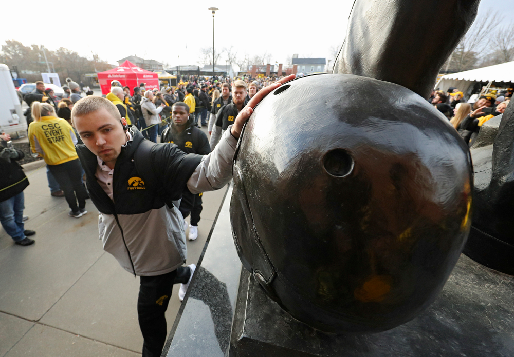 Iowa Hawkeyes quarterback Nate Stanley (4) touches the helmet on the Nile Kinnick statue before their game at Kinnick Stadium in Iowa City on Saturday, Nov 23, 2019. (Stephen Mally/hawkeyesports.com)