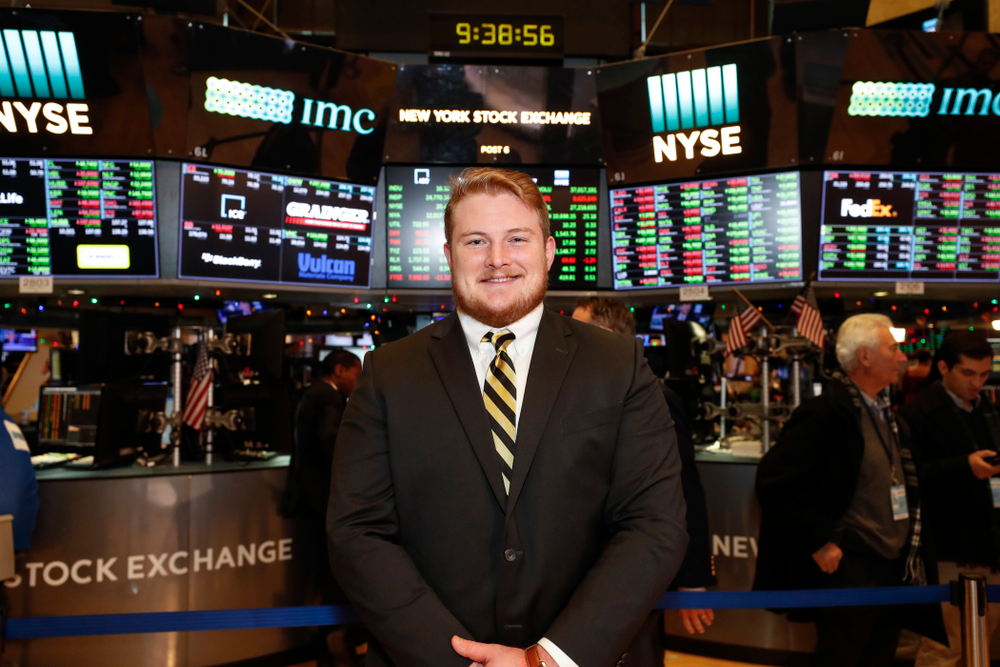 Iowa Hawkeyes linebacker Josey Jewell (43), defensive back Joshua Jackson (15), offensive lineman Sean Welsh (79) and head coach Kirk Ferentz ring the opening bell at the New York Stock Exchange Tuesday, December 26, 2017 in New York. (Brian Ray/hawkeyesports.com)