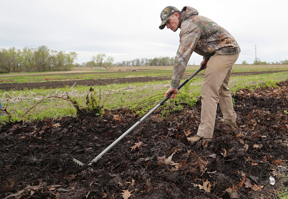 Iowa wrestlers work in the field for Grow: Johnson County at the Johnson County Historic Poor Farm during the 21st annual ISAAC Hawkeye Day of Caring in Iowa City on Sunday, Apr. 28, 2019. (Stephen Mally/hawkeyesports.com)