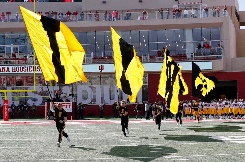 The Iowa Spirit Squad brings out the IOWA flags against the Indiana Hoosiers Saturday, October 13, 2018 at Memorial Stadium, in Bloomington, Ind. (Brian Ray/hawkeyesports.com)