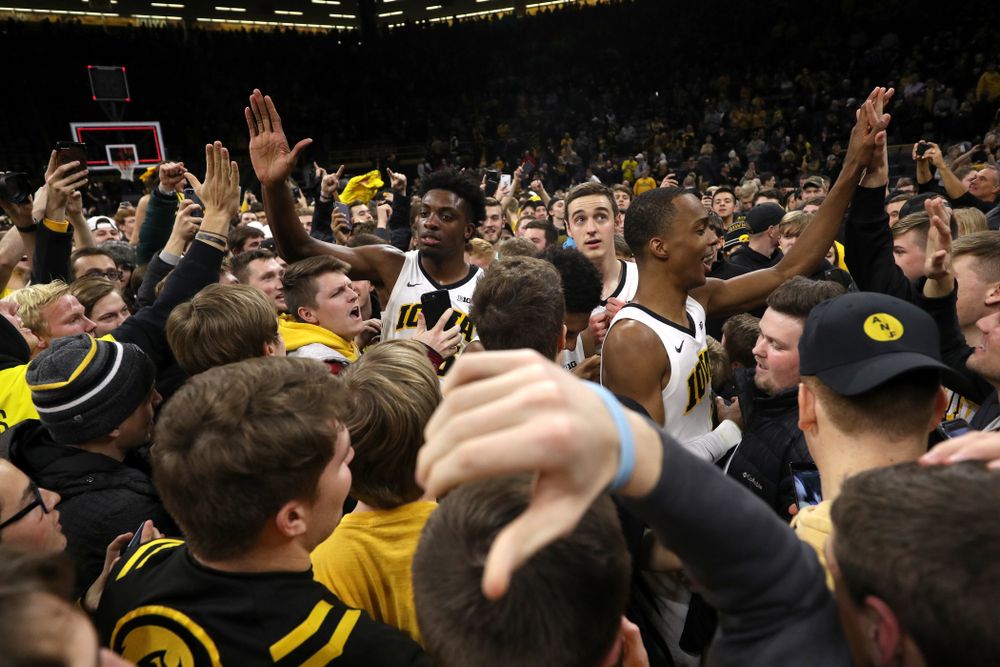 Iowa Hawkeyes guard Maishe Dailey (1) and forward Tyler Cook (25) celebrate with fans after defeating the Michigan Wolverines Friday, February 1, 2019 at Carver-Hawkeye Arena. (Brian Ray/hawkeyesports.com)