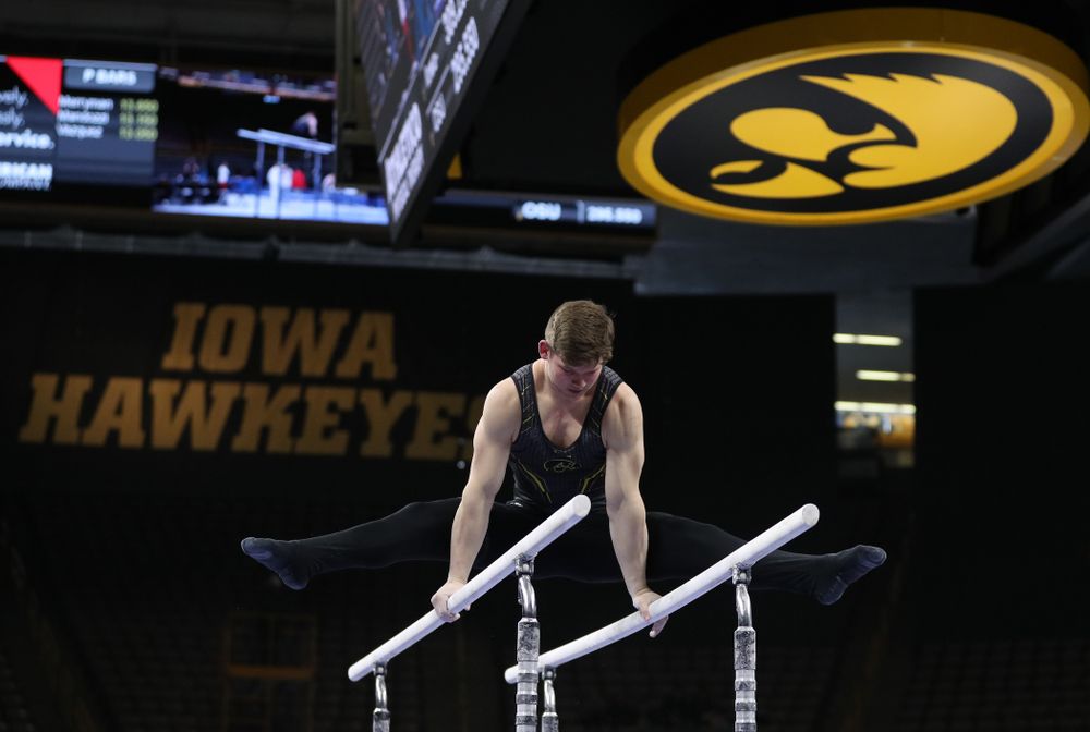 Iowa's Stewart Brown competes on the parallel bars against the Ohio State Buckeyes Saturday, March 16, 2019 at Carver-Hawkeye Arena. (Brian Ray/hawkeyesports.com)
