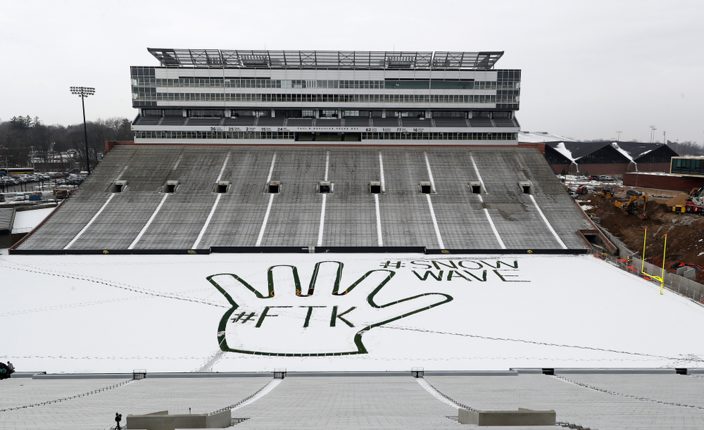 Members of the Iowa Athletics Turf Management staff create the #SnowWave for kids in the Stead Family Children's Hospital Thursday, February