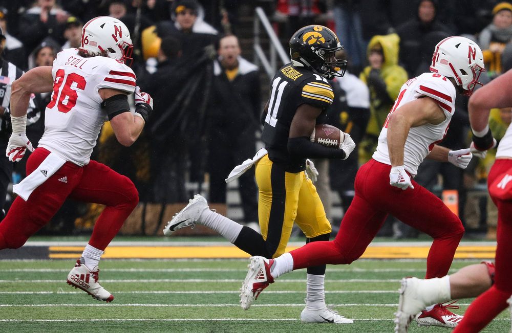 Iowa Hawkeyes defensive back Michael Ojemudia (11) returns an interception during a game against Nebraska at Kinnick Stadium on November 23, 2018. (Tork Mason/hawkeyesports.com)