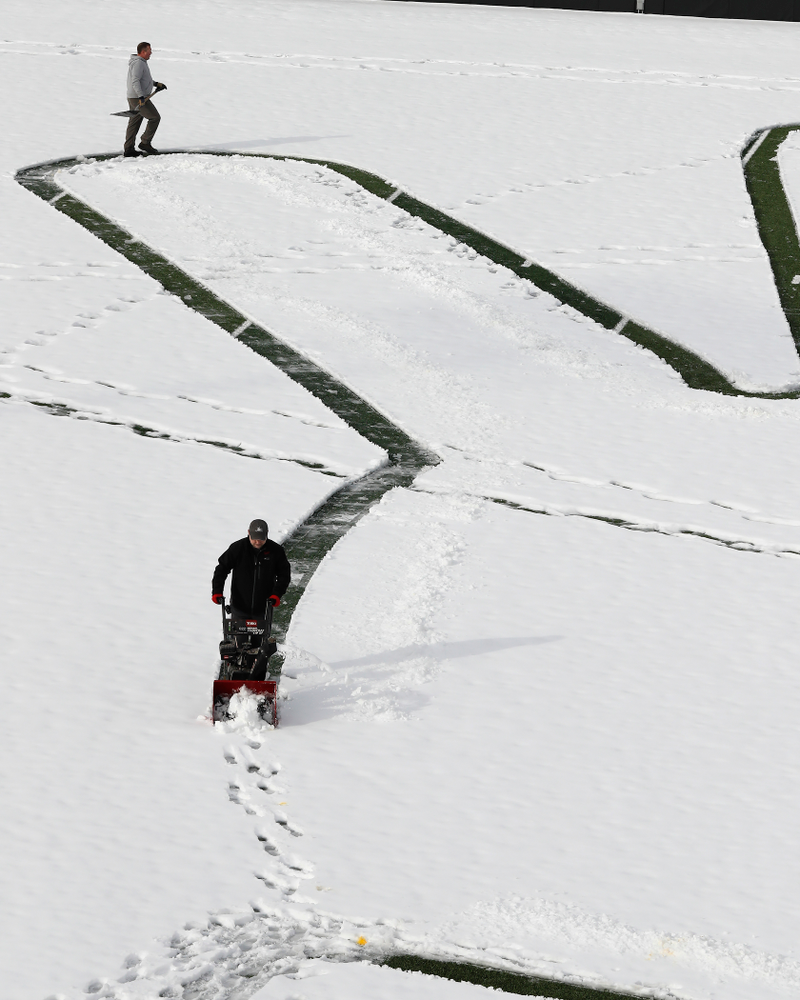Members of the Iowa Athletics Turf Management staff create the #SnowWave for kids in the Stead Family Children's Hospital Thursday, February