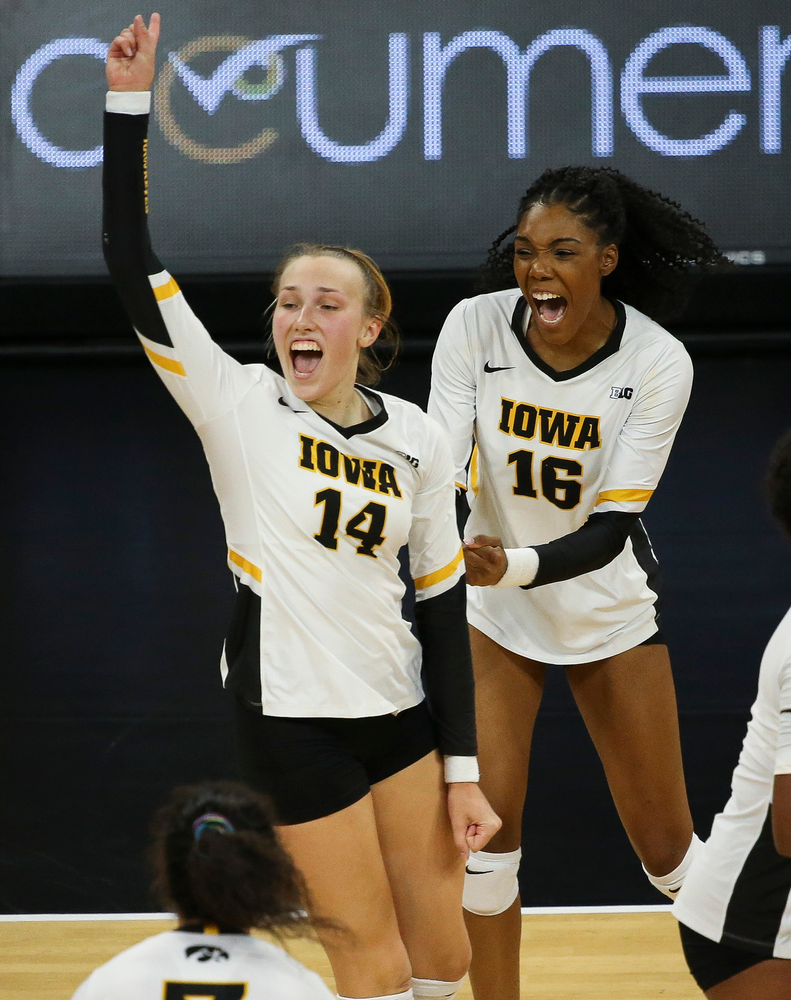 Iowa Hawkeyes outside hitter Cali Hoye (14) and Iowa Hawkeyes outside hitter Taylor Louis (16) react after winning a point during a game against Purdue at Carver-Hawkeye Arena on October 13, 2018. (Tork Mason/hawkeyesports.com)