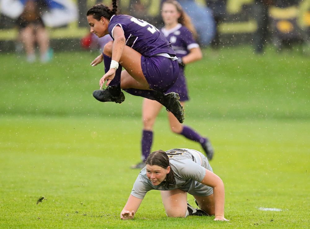 Iowa forward Samantha Tawharu (27) is tripped up as Northwestern’s Julietta Thron (99) flies over top during the second half of their match at the Iowa Soccer Complex in Iowa City on Sunday, Sep 29, 2019. (Stephen Mally/hawkeyesports.com)
