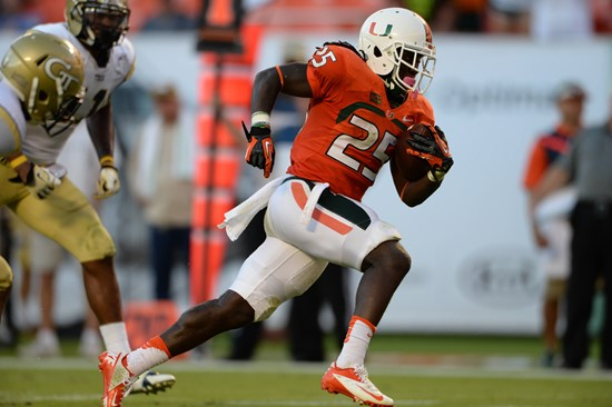 University of Miami Hurricanes running back Dallas Crawford #25 carries the ball in a game against the Georgia Tech Yellow Jackets at Sun Life Stadium...