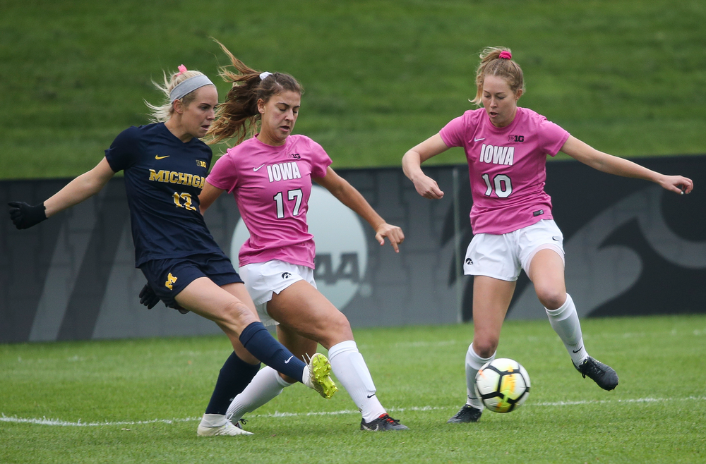 Iowa Hawkeyes defender Hannah Drkulec (17) and Iowa Hawkeyes midfielder Natalie Winters (10) make a tackle during a game against Michigan at the Iowa Soccer Complex on October 14, 2018. (Tork Mason/hawkeyesports.com)