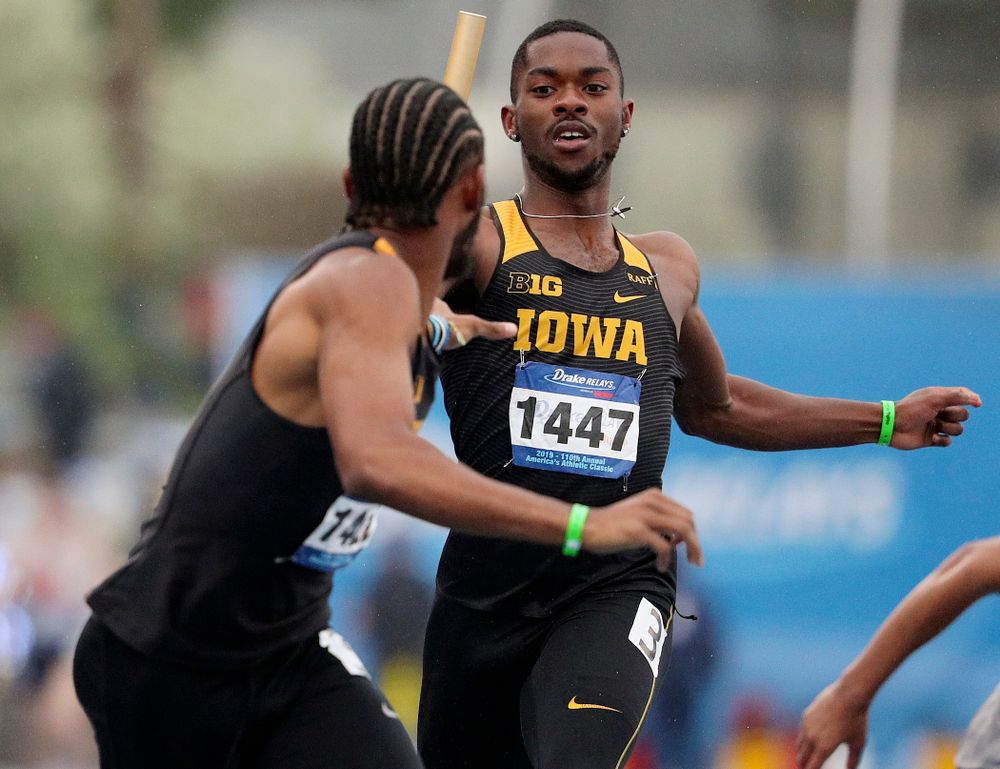 Iowa's Antonio Woodard (right) hands the baton off to Mar'yea Harris runs the men's sprint medley relay event during the third day of the Drake Relays at Drake Stadium in Des Moines on Saturday, Apr. 27, 2019. (Stephen Mally/hawkeyesports.com)