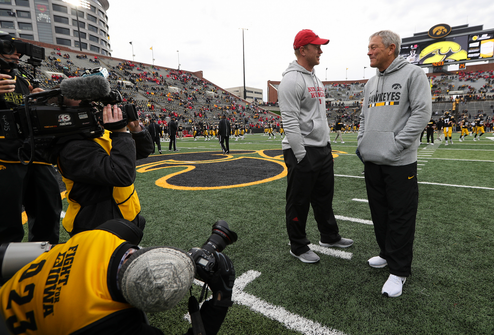 Iowa Hawkeyes head coach Kirk Ferentz talks with Nebraska Cornhuskers head coach Scott Frost before a game against Nebraska at Kinnick Stadium on November 23, 2018. (Tork Mason/hawkeyesports.com)