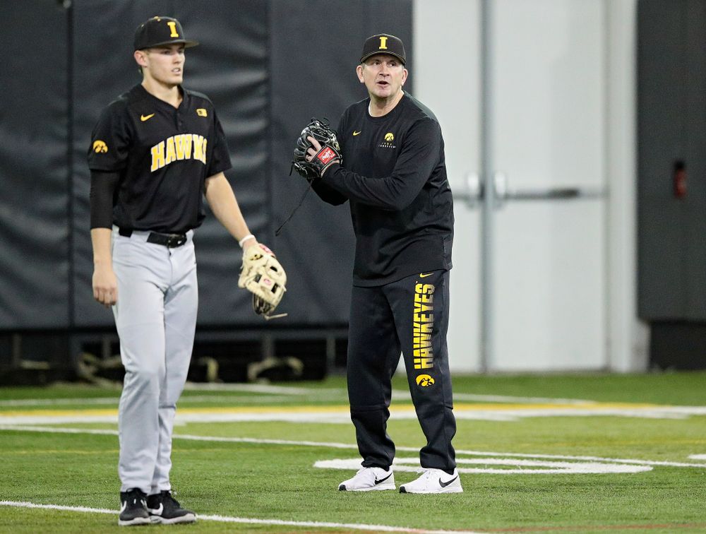 Iowa Hawkeyes head coach Rick Heller talks to his players as infielder/pitcher Dylan Nedved (17) looks on during practice at the Hansen Football Performance Center in Iowa City on Friday, January 24, 2020. (Stephen Mally/hawkeyesports.com)