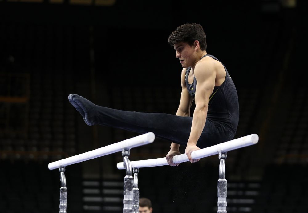 Iowa's Evan Davis competes on the parallel bars against the Ohio State Buckeyes Saturday, March 16, 2019 at Carver-Hawkeye Arena. (Brian Ray/hawkeyesports.com)