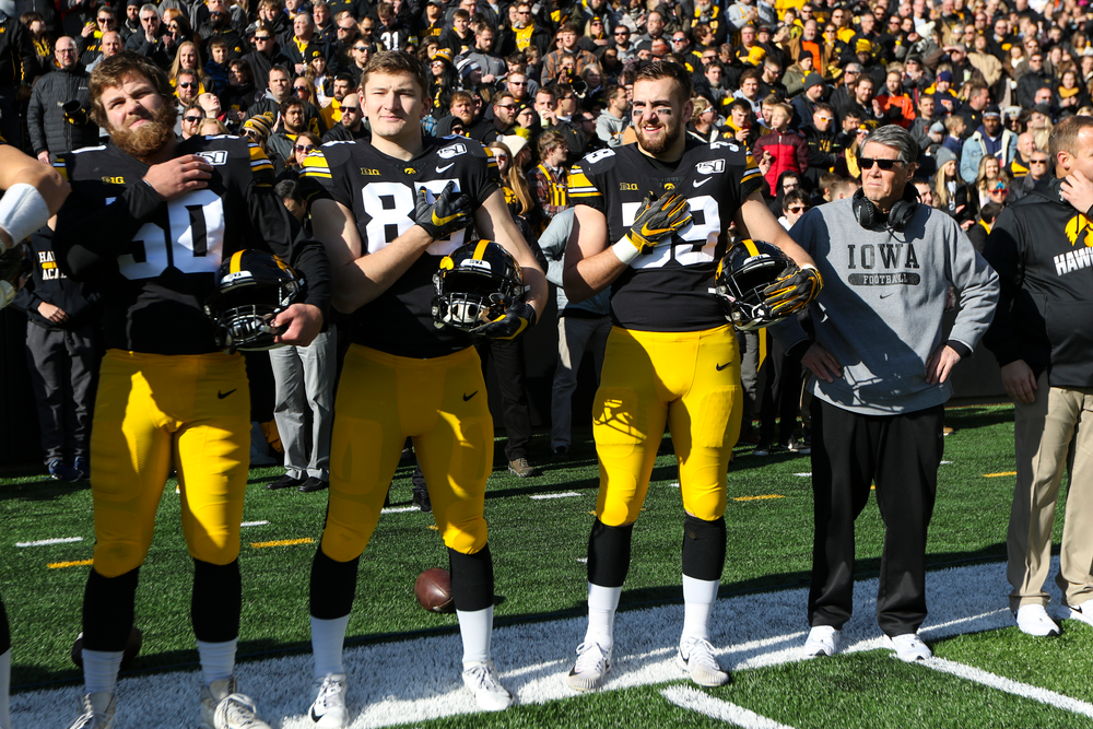 Iowa Hawkeyes long snapper Jackson Subbert (50), Iowa Hawkeyes long snapper Nate Vejvoda (85), Iowa Hawkeyes defensive end Nathan Nelson (59) and Iowa Hawkeyes quarterbacks coach Ken O'Keefe during Iowa football vs Illinois on Saturday, November 23, 2019 at Kinnick Stadium. (Lily Smith/hawkeyesports.com)