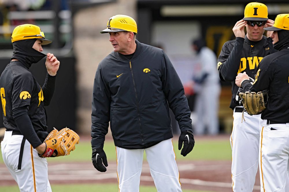 Iowa Hawkeyes head coach Rick Heller talks with his team during the third inning of their game against Illinois at Duane Banks Field in Iowa City on Saturday, Mar. 30, 2019. (Stephen Mally/hawkeyesports.com)