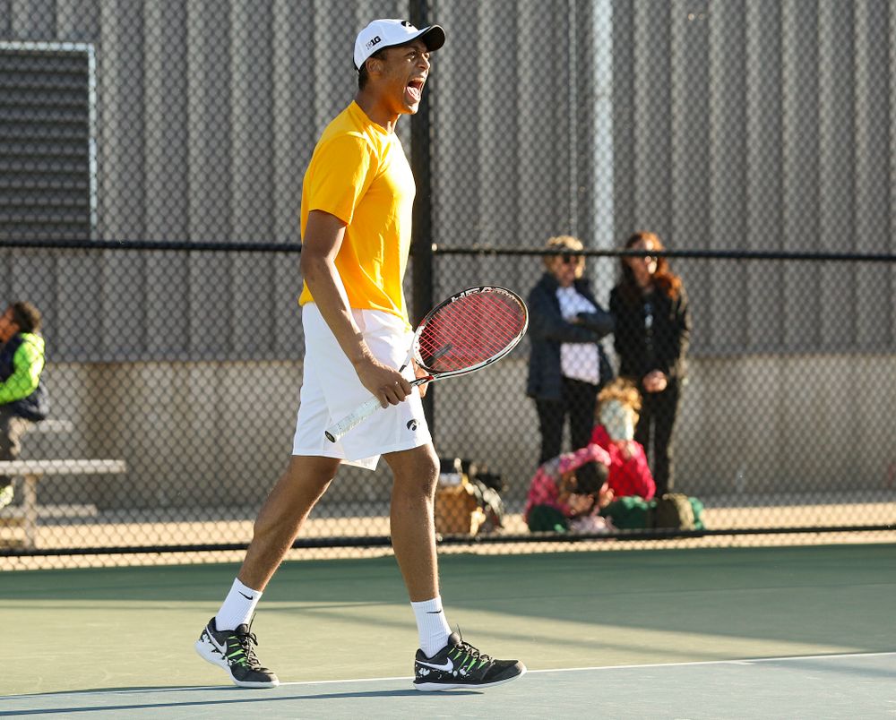 Iowa's Oliver Okonkwo celebrates during their doubles match again Michigan State at the Hawkeye Tennis and Recreation Complex in Iowa City on Friday, Apr. 19, 2019. (Stephen Mally/hawkeyesports.com)
