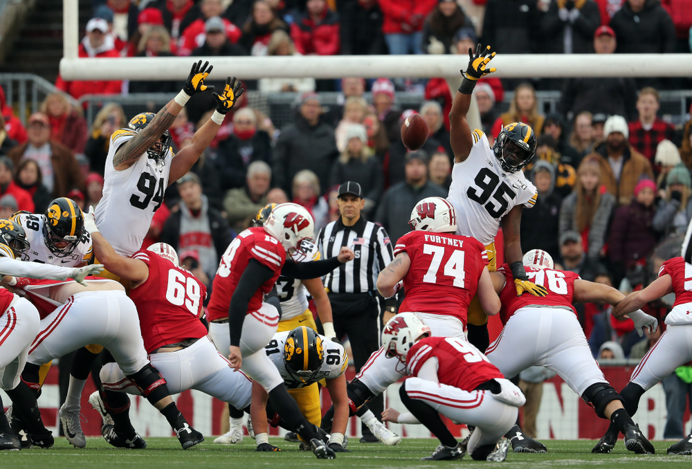 Iowa Hawkeyes defensive end A.J. Epenesa (94) and defensive lineman Cedrick Lattimore (95) against the Wisconsin Badgers Saturday, November 9, 2019 at Camp Randall Stadium in Madison, Wisc. (Brian Ray/hawkeyesports.com)