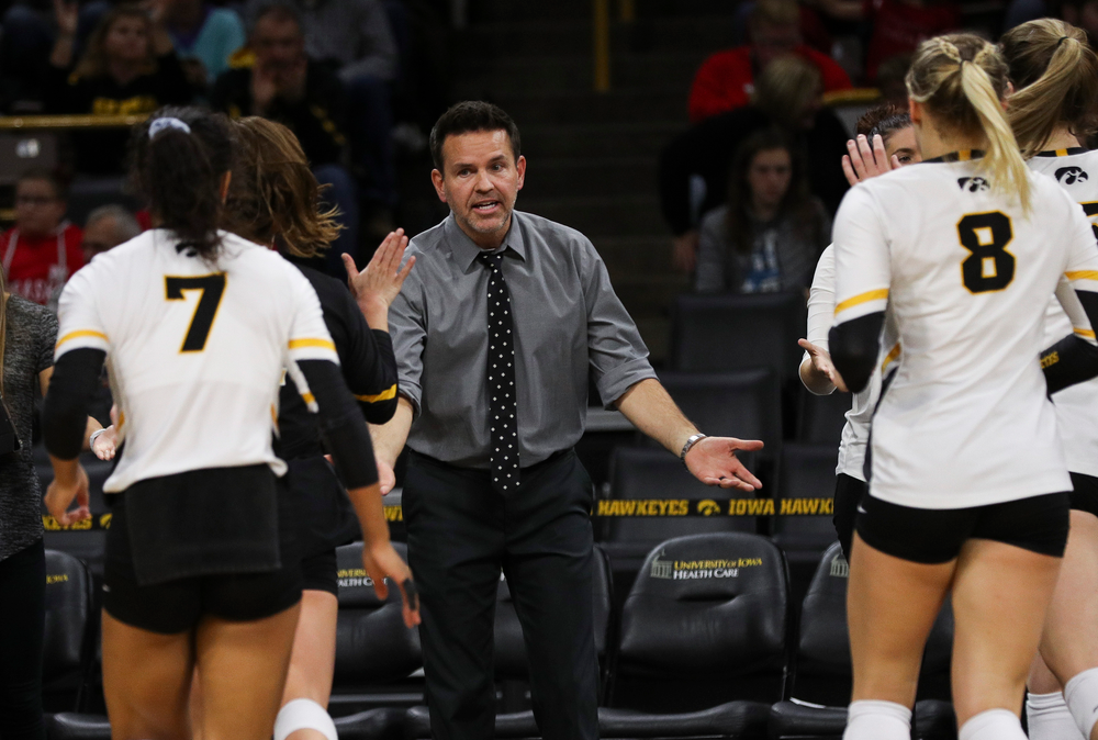 Iowa Hawkeyes head coach Bond Shymansky high fives players during a timeout during a match against Nebraska at Carver-Hawkeye Arena on November 7, 2018. (Tork Mason/hawkeyesports.com)