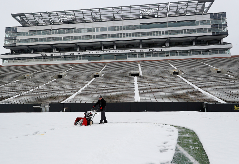 Members of the Iowa Athletics Turf Management staff create the #SnowWave for kids in the Stead Family Children's Hospital Thursday, February