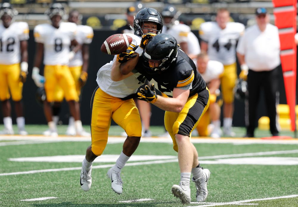 Iowa Hawkeyes tight end Shaun Beyer (42) and defensive back Josh Turner (4) during Kids Day Saturday, August 11, 2018 at Kinnick Stadium. (Brian Ray/hawkeyesports.com)