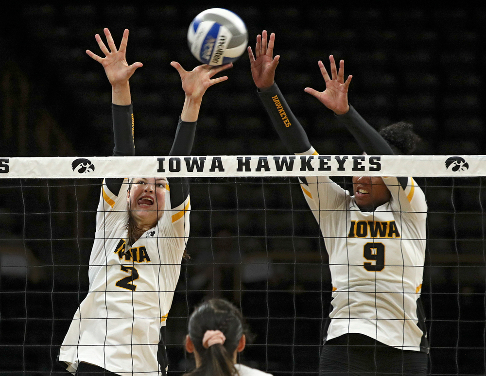 Iowa’s Courtney Buzzerio (2) gets her hand on the ball as Amiya Jones (9) tries for the block during their Big Ten/Pac-12 Challenge match at Carver-Hawkeye Arena in Iowa City on Saturday, Sep 7, 2019. (Stephen Mally/hawkeyesports.com)