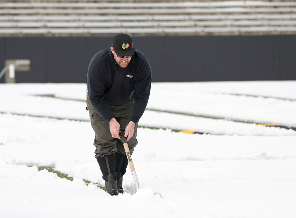 Members of the Iowa Athletics Turf Management staff create the #SnowWave for kids in the Stead Family Children's Hospital Thursday, February
