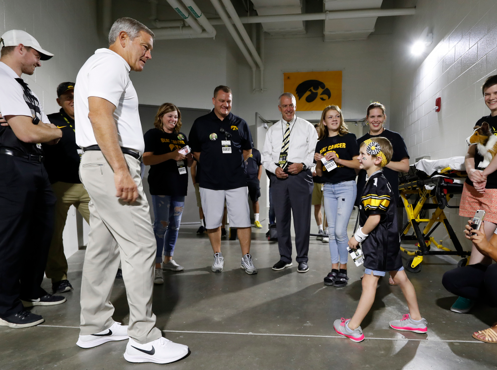 Iowa Hawkeyes head coach Kirk Ferentz talks with Kid Captain Harper Stribe and her family before the Hawkeyes game against the Iowa State Cyclones Saturday, September 8, 2018 at Kinnick Stadium. (Brian Ray/hawkeyesports.com)