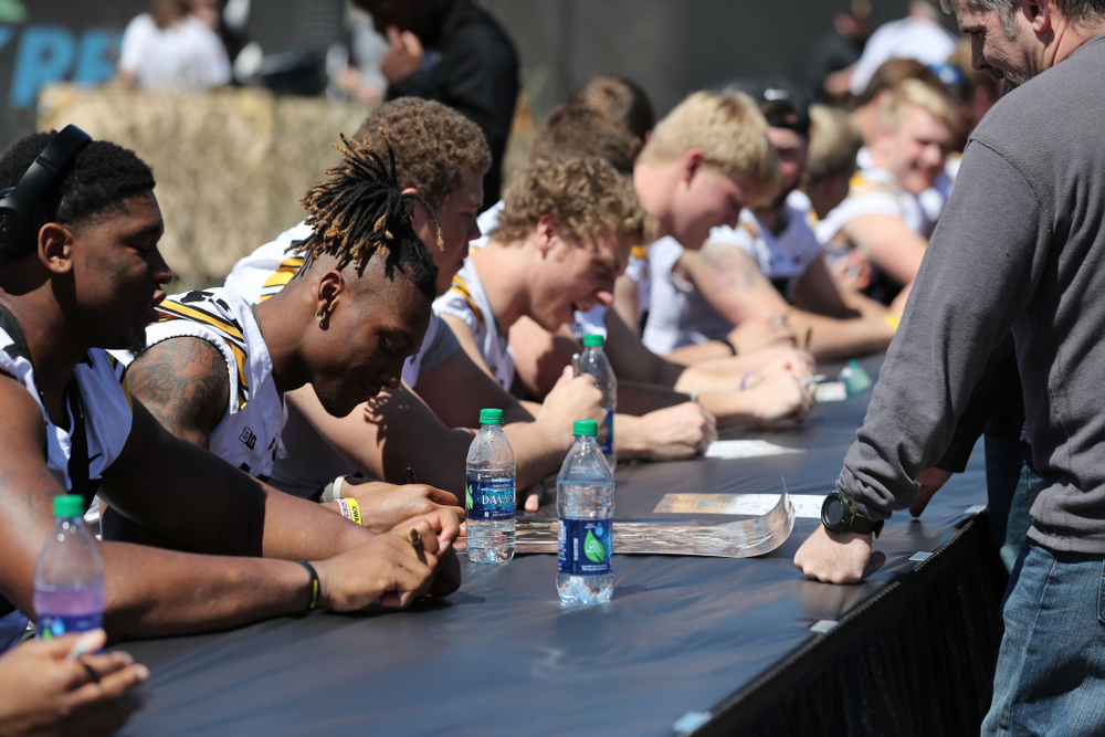 Members of the Iowa Football team sign autographs before the Iowa Hawkeyes game against the Nebraska Cornhuskers Saturday, April 20, 2019 at Duane Banks Field. (Brian Ray/hawkeyesports.com)