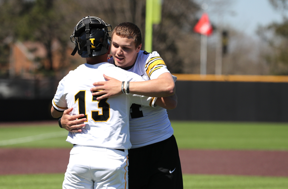 Iowa Hawkeyes quarterback Nate Stanley (4) throws out a first pitch against the Nebraska Cornhuskers Saturday, April 20, 2019 at Duane Banks Field. (Brian Ray/hawkeyesports.com)