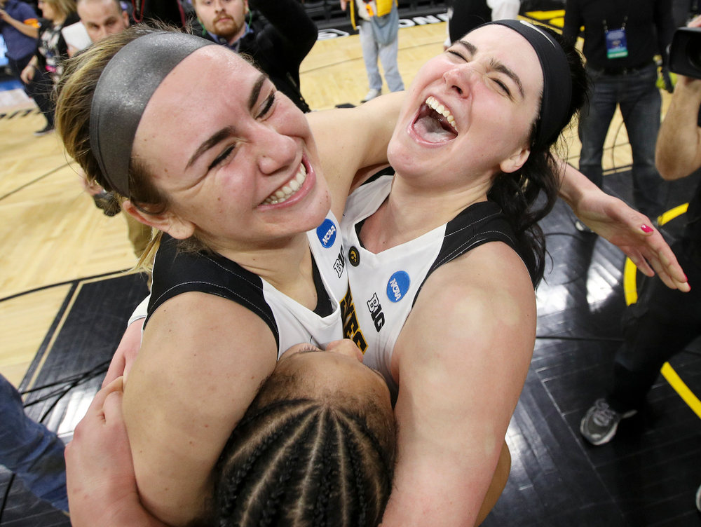 Iowa Hawkeyes forward Hannah Stewart (21), guard Tania Davis (11), and center Megan Gustafson (10) hug after winning their second round game in the 2019 NCAA Women's Basketball Tournament at Carver Hawkeye Arena in Iowa City on Sunday, Mar. 24, 2019. (Stephen Mally for hawkeyesports.com)
