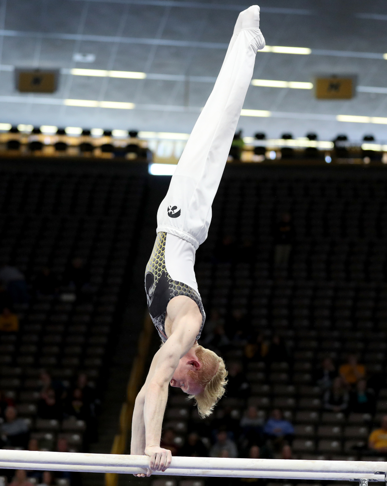 Iowa’s Nick Merryman competes on the parallel bars against UIC and Minnesota Saturday, February 1, 2020 at Carver-Hawkeye Arena. (Brian Ray/hawkeyesports.com)