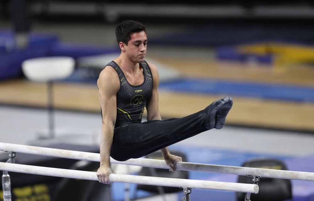 Iowa's Andrew Herrador competes on the parallel bars against Oklahoma Saturday, February 9, 2019 at Carver-Hawkeye Arena. (Brian Ray/hawkeyesports.com)