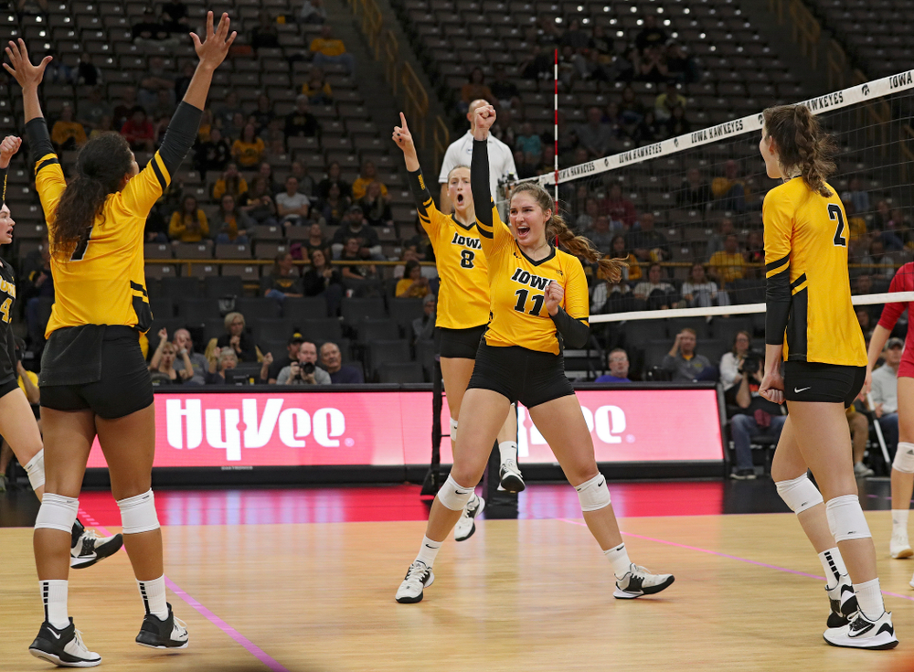 Iowa’s Brie Orr (7), Kyndra Hansen (8), Blythe Rients (11), and Courtney Buzzerio (2) celebrate a score during their match at Carver-Hawkeye Arena in Iowa City on Sunday, Oct 20, 2019. (Stephen Mally/hawkeyesports.com)