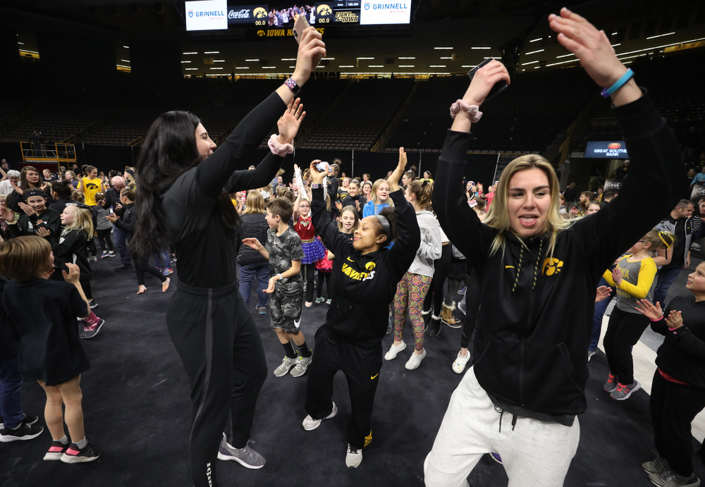 Iowa Women's Basketball seniors Megan Gustafson, Tania Davis, and forward Hannah Stewart (21) present the awards and dance the Cha Cha Slide following the Gymhawks meet against Illinois Saturday, February 16, 2019 at Carver-Hawkeye Arena. (Brian Ray/hawkeyesports.com)