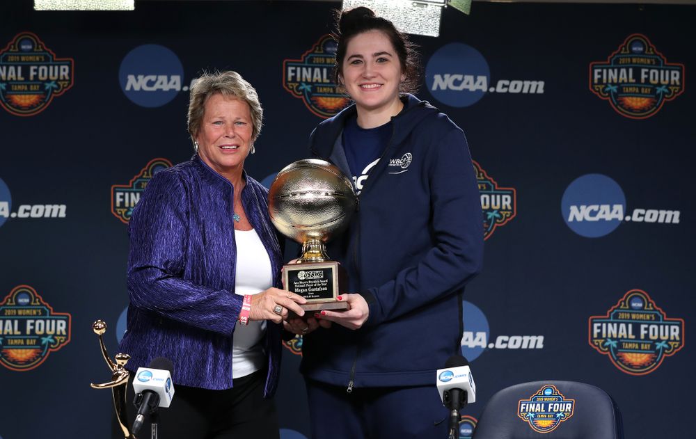 Iowa Hawkeyes forward Megan Gustafson (10) receives US Basketball Writers Association Ann Meyers Drysdale Player of the Year award from Ann Meyers Drysdale during a news conference Friday, April 5, 2019 at Amalie Arena in Tampa, FL. (Brian Ray/hawkeyesports.com)