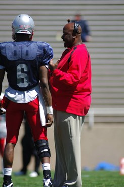 Head coach Mike Locksley talks with QB Donovan Porterie Saturday during the Cherry-Silver game.