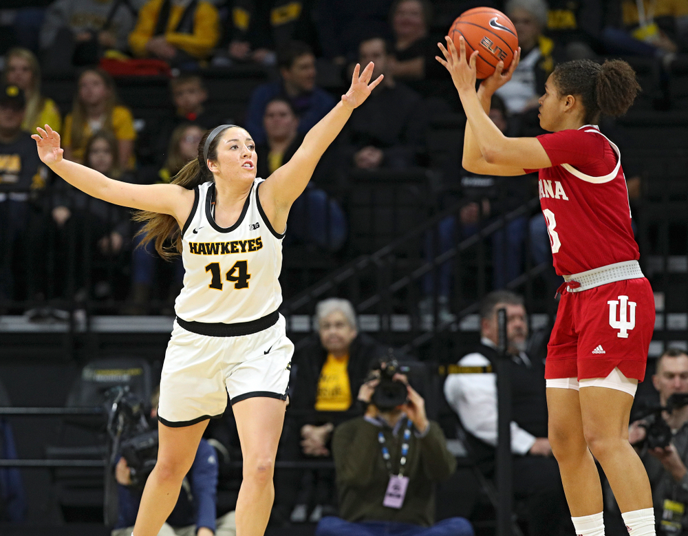 Iowa Hawkeyes guard Mckenna Warnock (14) defends during the first quarter of their game at Carver-Hawkeye Arena in Iowa City on Sunday, January 12, 2020. (Stephen Mally/hawkeyesports.com)