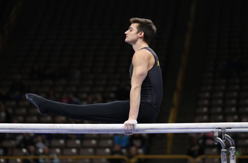 Iowa's Mitch Mandozzi competes on the parallel bars against the Ohio State Buckeyes Saturday, March 16, 2019 at Carver-Hawkeye Arena. (Brian Ray/hawkeyesports.com)