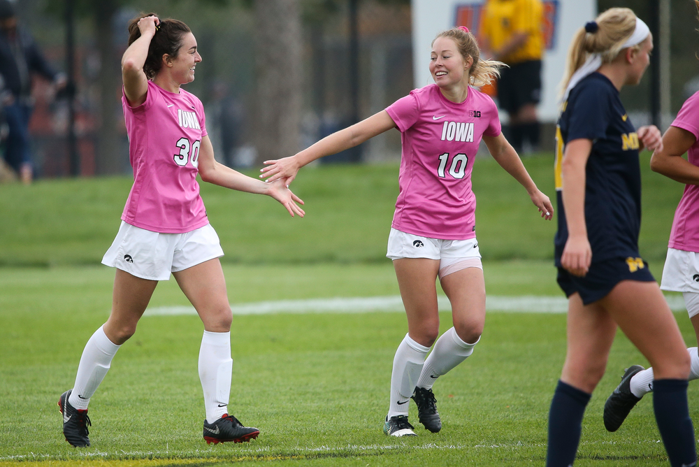 Iowa Hawkeyes forward Devin Burns (30) and Iowa Hawkeyes midfielder Natalie Winters (10) celebrate after Burns' second half goal during a game against Michigan at the Iowa Soccer Complex on October 14, 2018. (Tork Mason/hawkeyesports.com)