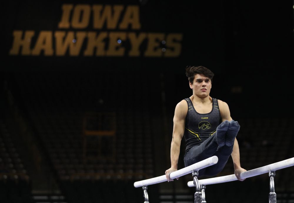Iowa's Evan Davis competes on the parallel bars against the Ohio State Buckeyes Saturday, March 16, 2019 at Carver-Hawkeye Arena. (Brian Ray/hawkeyesports.com)